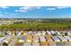 Expansive aerial view of a residential area featuring neatly arranged homes, trees, and open fields at 312 Emmalee Pl, The Villages, FL 32162