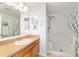 Well-maintained bathroom featuring a step-in shower and vanity with ample storage at 312 Emmalee Pl, The Villages, FL 32162
