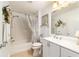 Bright bathroom with a shower and tub combination, a white vanity, and neutral decor at 312 Emmalee Pl, The Villages, FL 32162