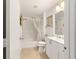 Bright bathroom with a shower and tub combination, a white vanity, and neutral decor at 312 Emmalee Pl, The Villages, FL 32162