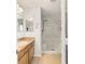 Bathroom featuring a step-in shower and vanity with modern fixtures at 312 Emmalee Pl, The Villages, FL 32162