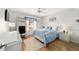 Cozy bedroom features a comfortable bed, a ceiling fan and lots of natural light at 312 Emmalee Pl, The Villages, FL 32162