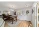 Bright dining room with wood floors offers views of the backyard at 312 Emmalee Pl, The Villages, FL 32162