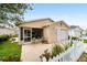 Inviting single-story home boasts a screened porch, attached garage, and manicured landscaping at 312 Emmalee Pl, The Villages, FL 32162