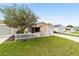 Street view of a single-story home with an attached garage and well maintained lawn and landscaping at 312 Emmalee Pl, The Villages, FL 32162