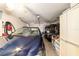 A well-organized garage with a car, golf cart, and plenty of storage space at 312 Emmalee Pl, The Villages, FL 32162