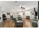 Open living room with hardwood floors and view to dining area at 312 Emmalee Pl, The Villages, FL 32162