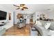 Open living room with hardwood floors and view to kitchen and dining area at 312 Emmalee Pl, The Villages, FL 32162