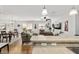Open-concept living room seamlessly connects to the kitchen, offering ample natural light and comfortable seating at 312 Emmalee Pl, The Villages, FL 32162