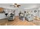 Open living room with hardwood floors and view to kitchen and dining area at 312 Emmalee Pl, The Villages, FL 32162
