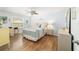 Serene main bedroom featuring a decorative ceiling fan, light blue walls, and wood look floors at 312 Emmalee Pl, The Villages, FL 32162