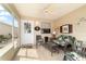 This cozy screened patio features comfortable seating and a ceiling fan at 312 Emmalee Pl, The Villages, FL 32162