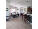 Open dining area with table and chairs, bar seating, and tile flooring, perfect for entertaining at 326 Crystal Pond Ave, Deland, FL 32720