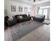 Comfortable living room features neutral walls, modern furnishings, and a decorative patterned area rug at 326 Crystal Pond Ave, Deland, FL 32720
