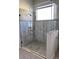 Modern shower features a glass door, tiled walls, and mosaic tile floors at 326 Crystal Pond Ave, Deland, FL 32720