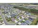 Wide aerial view of a residential area featuring neatly arranged houses, green lawns, and tree coverage at 3329 Boyd Cir, Oxford, FL 34484