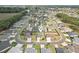 Expansive aerial view of a neighborhood featuring well-maintained homes and lush greenery at 3329 Boyd Cir, Oxford, FL 34484