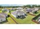 Aerial view of a private fenced backyard with screened lanai, patio area, and lush green lawn at 3329 Boyd Cir, Oxford, FL 34484