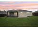 Backyard features a screened lanai, green lawn, privacy fence offering a relaxing outdoor space at 3329 Boyd Cir, Oxford, FL 34484