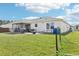 Large backyard features a patio for outdoor dining and a lush lawn, perfect for recreation and relaxation at 3329 Boyd Cir, Oxford, FL 34484