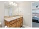 Well-lit bathroom featuring a vanity with a granite countertop, decorative pulls, and a large mirror at 3329 Boyd Cir, Oxford, FL 34484