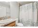 Well-lit bathroom featuring a vanity with a granite countertop and a shower/tub combo with a decorative shower curtain at 3329 Boyd Cir, Oxford, FL 34484