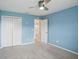 Bedroom with a ceiling fan and an adjoining door to the bathroom at 3329 Boyd Cir, Oxford, FL 34484
