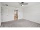 Spacious carpeted bedroom with a ceiling fan and attached bathroom at 3329 Boyd Cir, Oxford, FL 34484