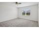 Bright bedroom with a ceiling fan and a window overlooking the backyard at 3329 Boyd Cir, Oxford, FL 34484