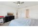 Bright bedroom with a ceiling fan, blue bedding and dark furniture at 3329 Boyd Cir, Oxford, FL 34484
