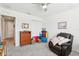 Cozy bedroom with dark wood dresser and comfortable recliner at 3329 Boyd Cir, Oxford, FL 34484