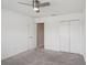 Bedroom with neutral walls, carpeting, ceiling fan and access to closet and en-suite bath at 3329 Boyd Cir, Oxford, FL 34484