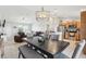 Open-concept dining room with dark wood table and views of the kitchen and living room at 3329 Boyd Cir, Oxford, FL 34484