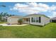 Single-Gathering home with a well-manicured lawn, attached garage, and tidy landscaping at 3329 Boyd Cir, Oxford, FL 34484