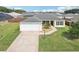 Charming one-story home featuring a well-manicured lawn, a driveway, and an attached two-car garage at 3329 Boyd Cir, Oxford, FL 34484