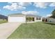 Charming single-story home features a well-manicured lawn and attached two car garage at 3329 Boyd Cir, Oxford, FL 34484