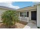 Inviting front entrance featuring a tidy garden, a covered porch, and a modern front door at 3329 Boyd Cir, Oxford, FL 34484