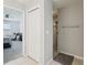 Hallway provides entry to the bathroom with a shower, as well as to a carpeted bedroom at 3329 Boyd Cir, Oxford, FL 34484