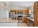 Kitchen area with stainless steel appliances, light wood cabinets, and granite countertops at 3329 Boyd Cir, Oxford, FL 34484