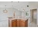Open kitchen featuring granite countertop peninsula with dinette seating and pendant lighting at 3329 Boyd Cir, Oxford, FL 34484