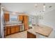 Updated kitchen with light wood cabinets, granite counters, stainless dishwasher, and sliding door at 3329 Boyd Cir, Oxford, FL 34484