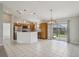 Open kitchen featuring stainless appliances, tile flooring, and sliding glass door to the backyard at 3329 Boyd Cir, Oxford, FL 34484