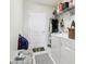 Functional laundry room with a washer, dryer, shelving for storage, and a convenient exterior door at 3329 Boyd Cir, Oxford, FL 34484