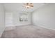 Bright living room features neutral paint, plush carpeting, ceiling fan, and plenty of natural light at 3329 Boyd Cir, Oxford, FL 34484