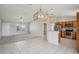 Open concept living room and kitchen with tile flooring, granite counters, stainless appliances and breakfast bar at 3329 Boyd Cir, Oxford, FL 34484