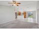 Spacious living room with open access to kitchen area and sliding glass door to the backyard at 3329 Boyd Cir, Oxford, FL 34484