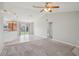 Living room adjacent to the kitchen and dinette area with tile flooring and sliding glass door at 3329 Boyd Cir, Oxford, FL 34484