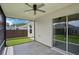 View of the screened patio features a ceiling fan and sliding glass doors to the interior at 3329 Boyd Cir, Oxford, FL 34484