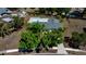 Aerial view of a well-maintained home with mature trees, a backyard pool, and a private fenced yard at 3415 Sail Fish Ave, Fruitland Park, FL 34731