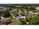 An aerial view of a single-Gathering home with a screened-in pool, a fenced backyard, and mature trees at 3415 Sail Fish Ave, Fruitland Park, FL 34731